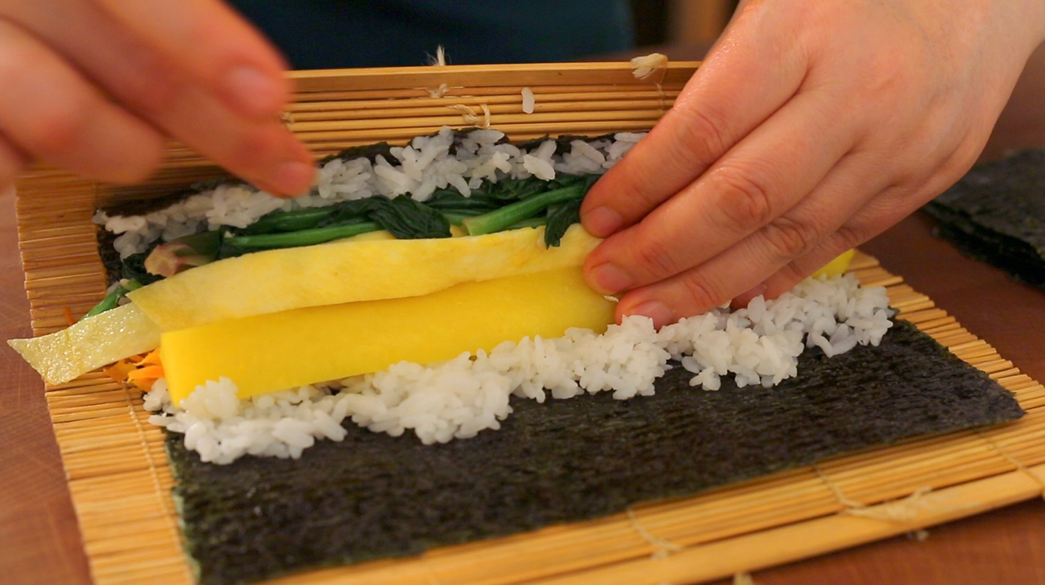 kimbap being rolled